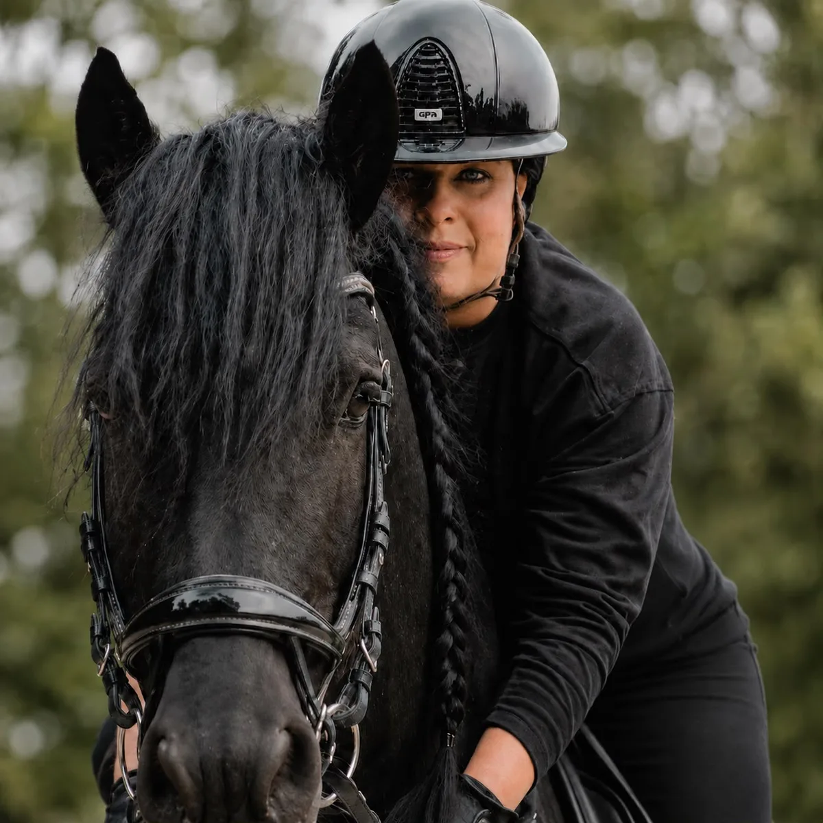 Caroline with one of her Friesian horses
