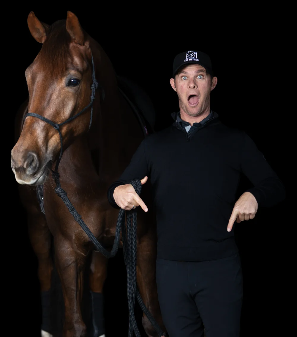 Tristan Tucker with a chestnut horse, pointing down