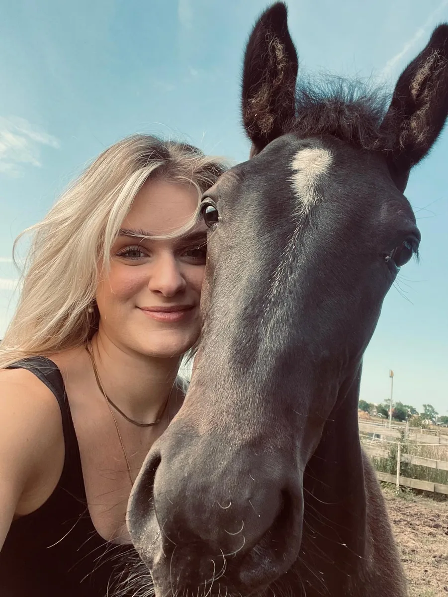 Lindsey Bakker with her young black horse