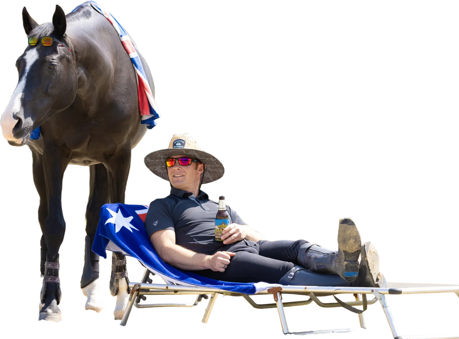 Tristan Tucker relaxing on a sun lounger while a bay horse stands behind him