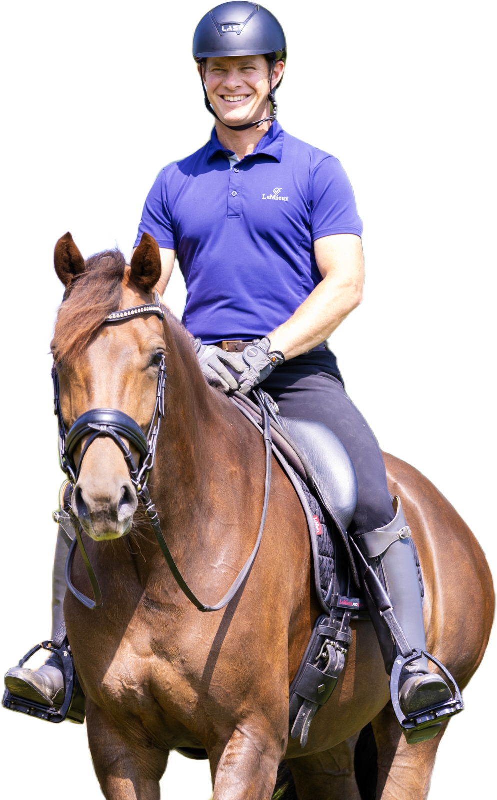 Tristan Tucker smiling in the saddle on a relaxed bay horse standing on a loose rein