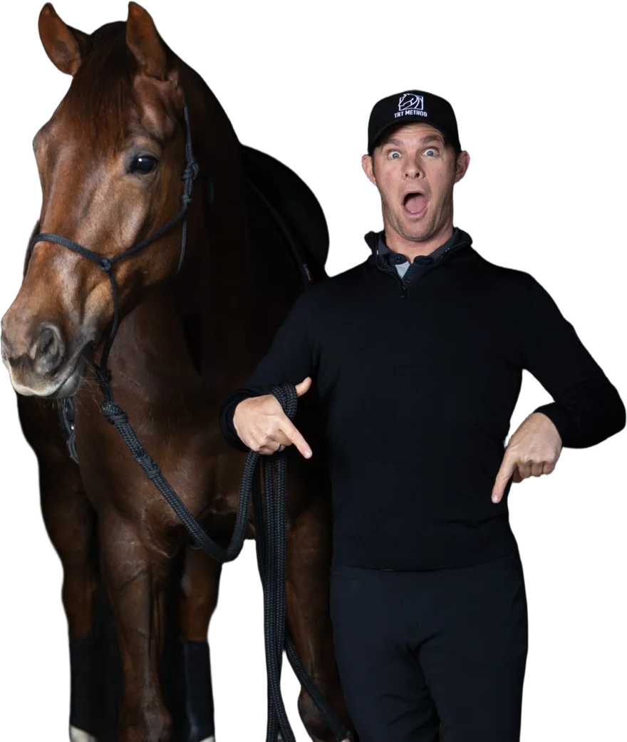 Tristan Tucker pointing down beside a bay horse