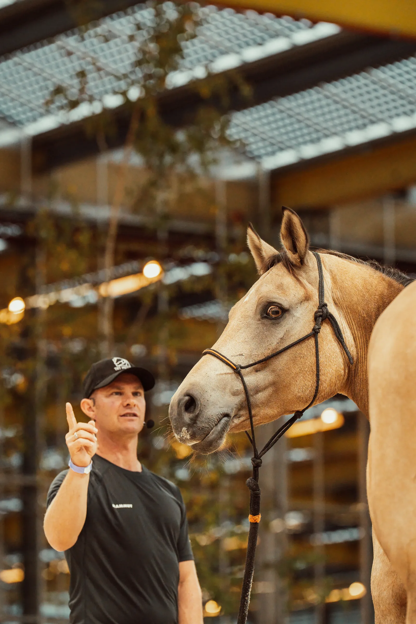 Tristan Tucker teaching beside a horse during a Saturday clinic at Horse Event 2026